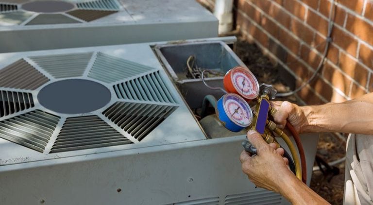 Repair person working on an air conditioning unit.
