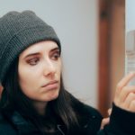 Person adjusting their thermostat in an effort to get the furnace to turn on.