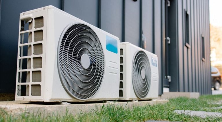 An air conditioning unit, outside of a home.